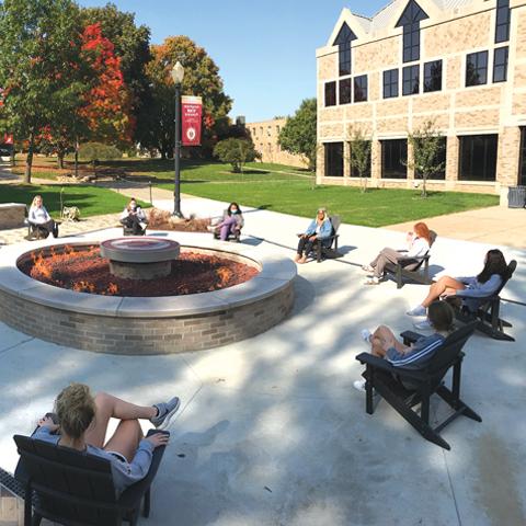 Students gathered around the campus fire pit